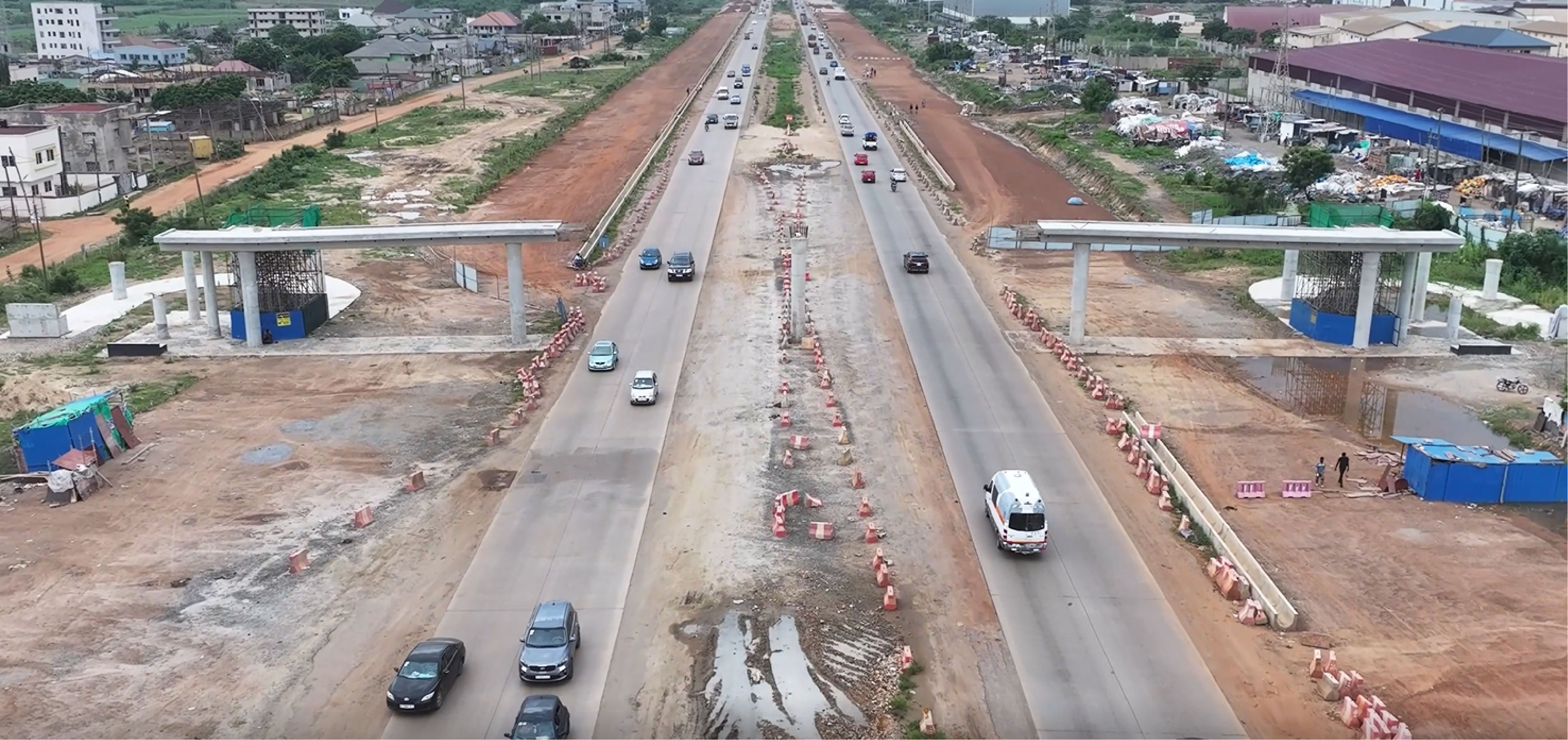 Aerial view of the corridor with two overpass deck structures under construction over the roadway