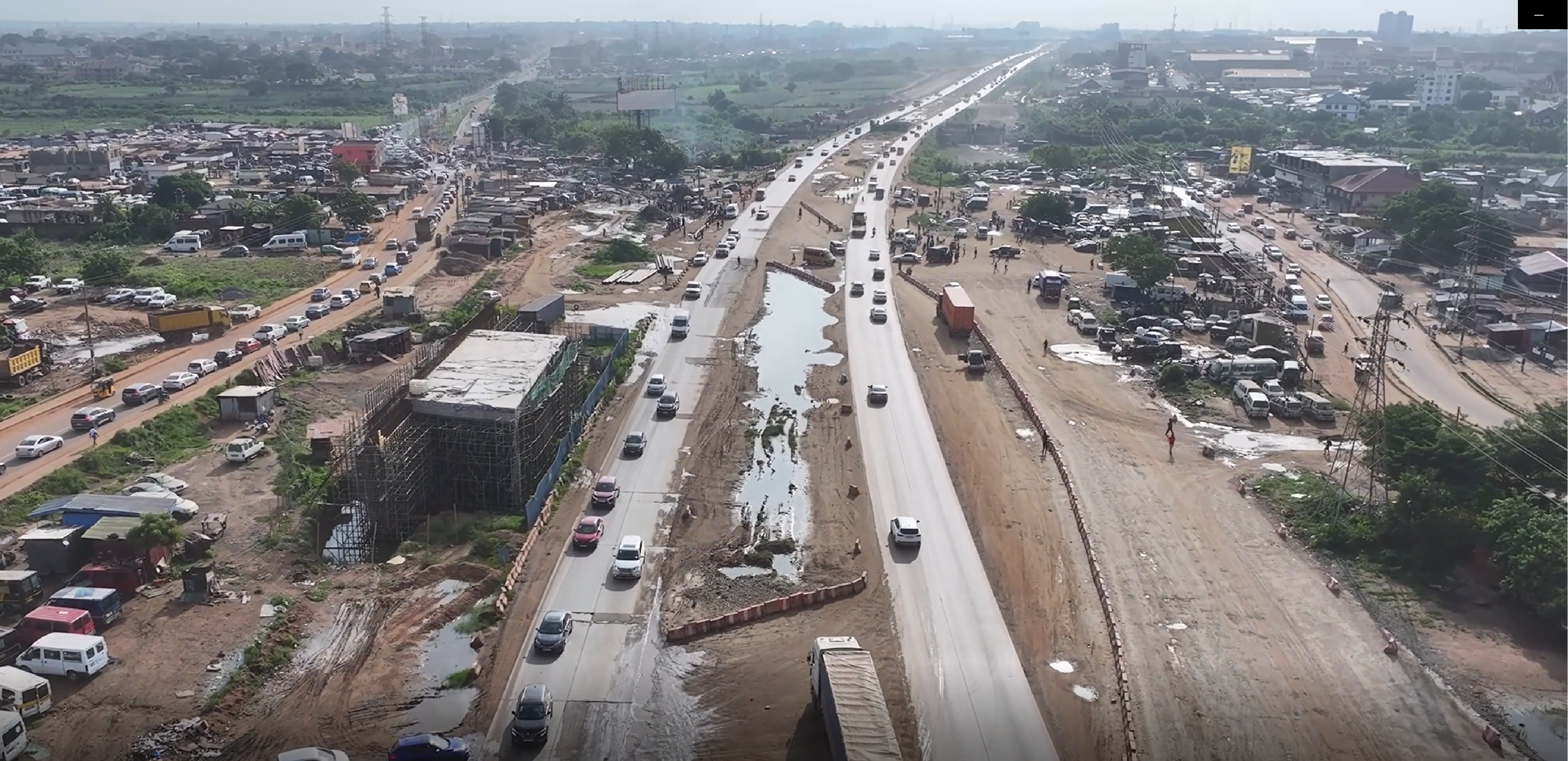 Aerial view of the Section 1 corridor under construction, with traffic on partially completed carriageways