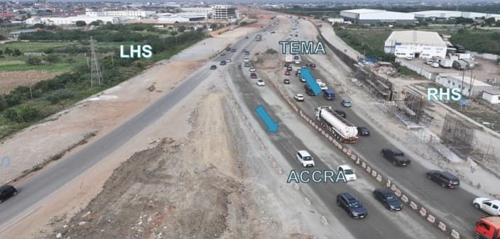 Footing wall construction on the right-hand side at Community 18 Interchange between Km 12+010 and Km 12+910, with live traffic in both directions